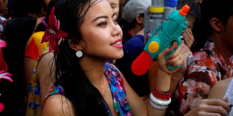 A reveller reacts during a water fight at Songkran Festival celebrations in Bangkok